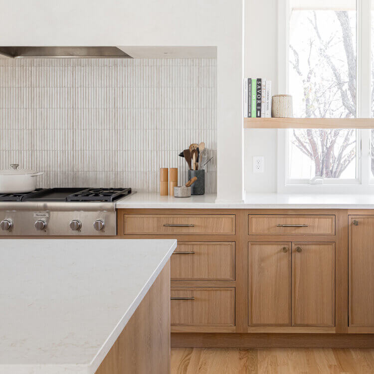 A beautiful Alcove style cooking zone area of the kitchen featuring bight white and raw wood color palette.