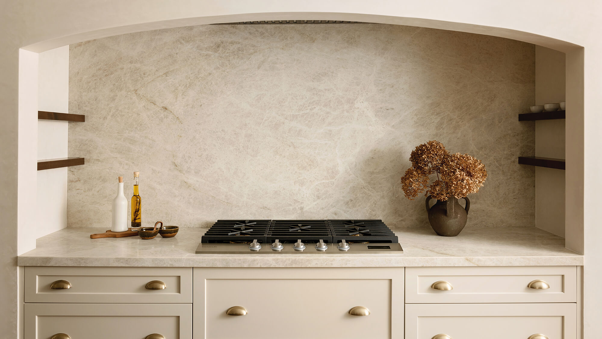 A stunning range alcove space with off-white cabinets and matching wall.