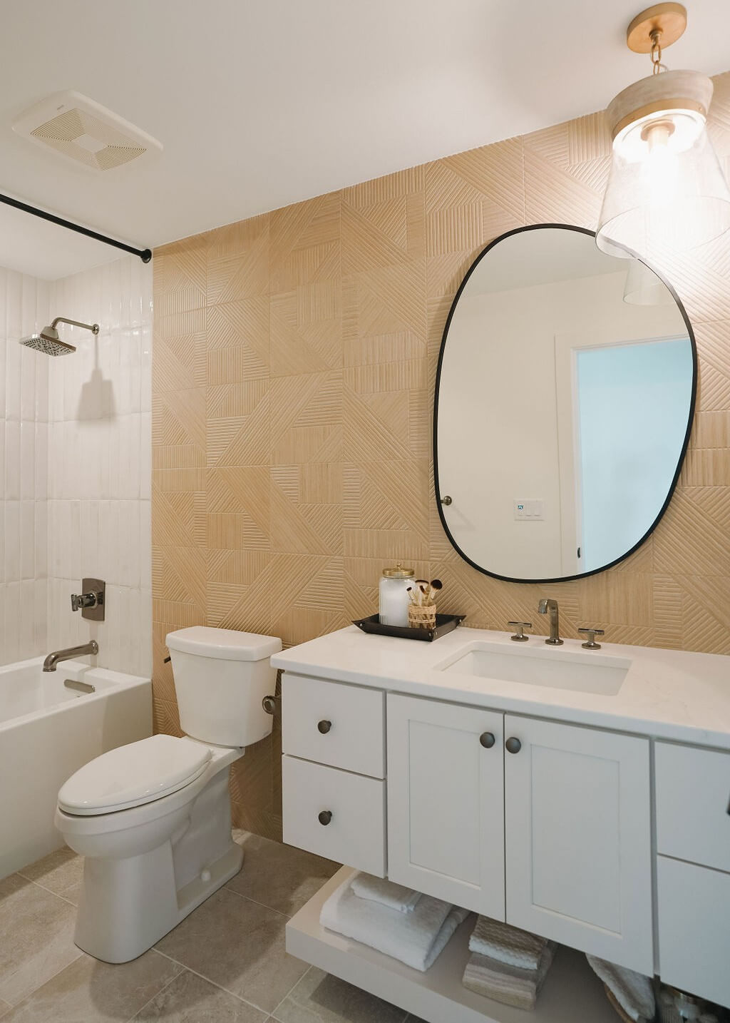 Luxurious bathroom vanity showcases soft painted cabinets accented by polished chrome knobs and pulls. Clean lines, generous drawer storage, and a bright quartz countertop create a timeless bathroom design that feels fresh and sophisticated.
